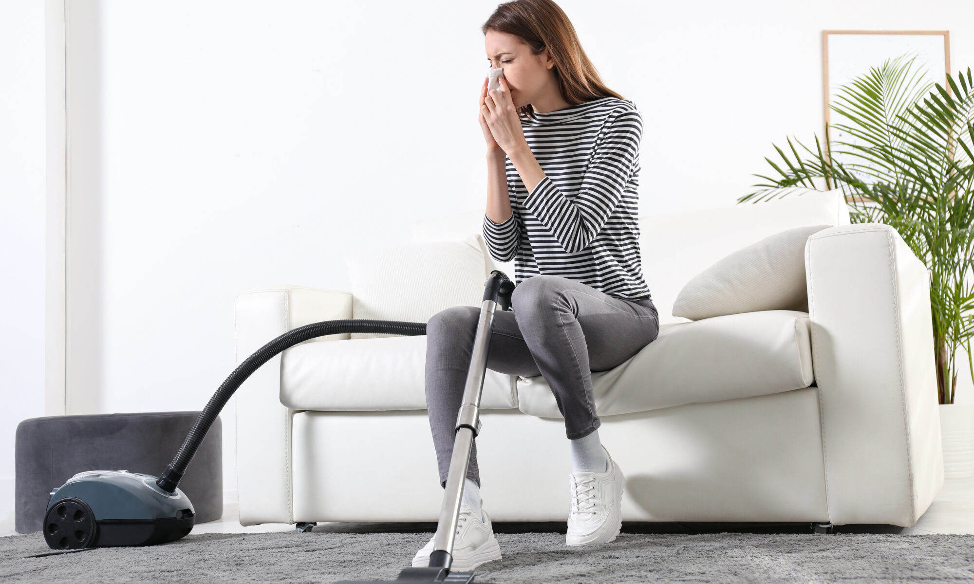 Young,Woman,Suffering,From,Dust,Allergy,While,Vacuuming,House